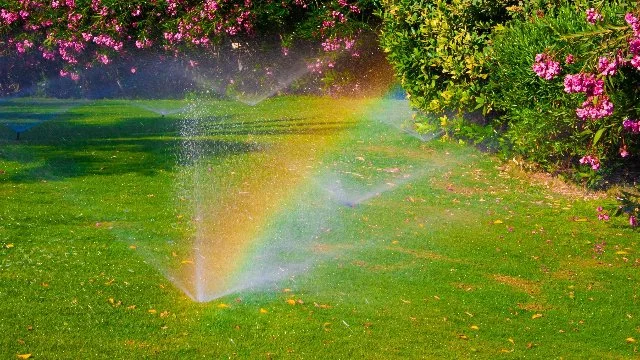 Sprinkler running causing rainbow at property in Saddle River, NJ.